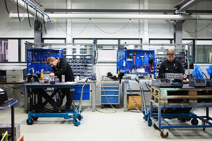 Two workers work with valve block production at the factory in Kongsberg, Norway