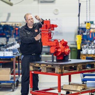 Image of a block in a work environment, with a person interacting with the block. 