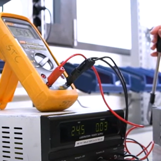 Image of SAC in use at a workshop, with equipment in the background, demonstrating a practical application of the product.