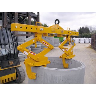 An image of a manhole ring lifting yoke from BSV in use at a construction site. The lifting yoke is lifting a large manhole ring, and the workers on site ensure the lift is performed safely and efficiently.