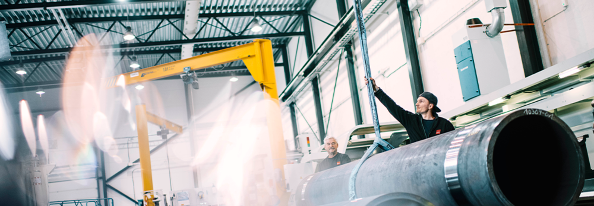 Two workers handling a cylinder at the factory in Rissa